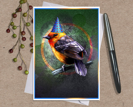 Photo of a greeting card posed with berries and an ink pen. The card features a flame-colored tanager in a blue conical party hat against a green and purple background.