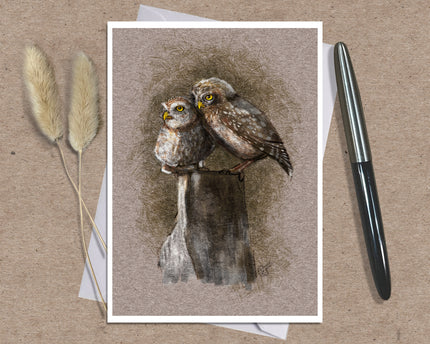 Product photo of a bird greeting card in brown featuring two burrowing pygmy owls on a stump.