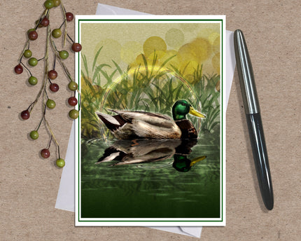 Illustrated greeting card featuring a mallard duck against a brown kraft paper background with a sprig of berries and an ink pen.