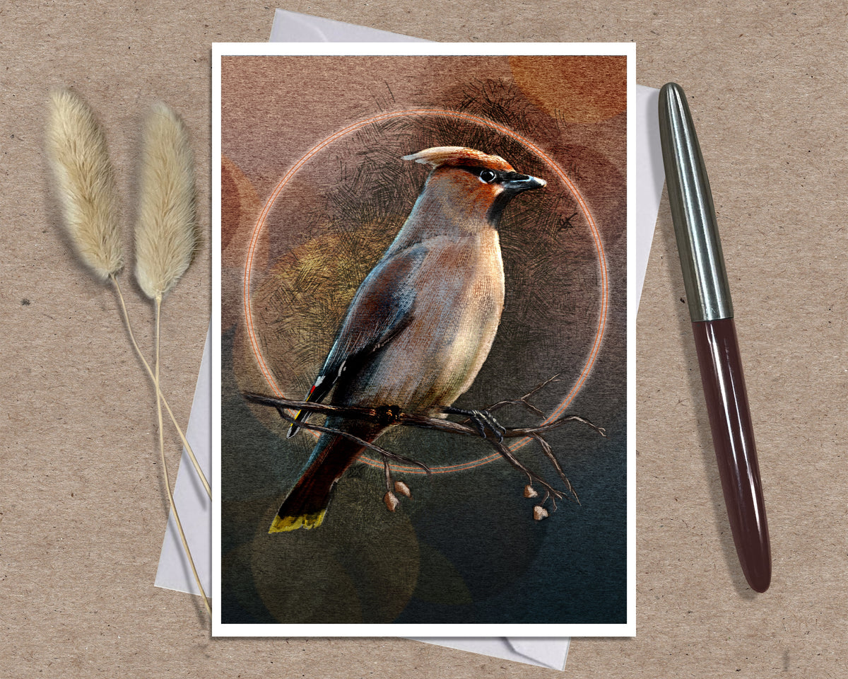 An art print featuring a detailed bird illustration with a circular halo motif, styled on a brown textured surface with a silver pen and dried grass stems.