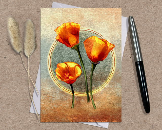 Greeting card with orange flowers on a textured surface with a pen and dried plants.