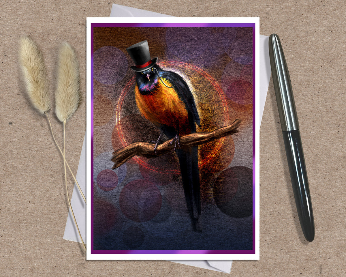 An art print greeting card featuring a colorful bird wearing a black top hat and glasses while perched on a branch, styled on a kraft paper background with a silver pen and dried grass stems.