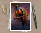 An art print greeting card featuring a colorful bird wearing a black top hat and glasses while perched on a branch, styled on a kraft paper background with a silver pen and dried grass stems.