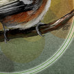 A closeup of textured stylized print of a bird's talons on a branch.