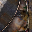 Close-up of a texture with a partially visible face and coat.