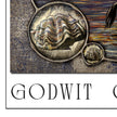 Decorative oyster design on a textured surface with 'GODWIT' text.