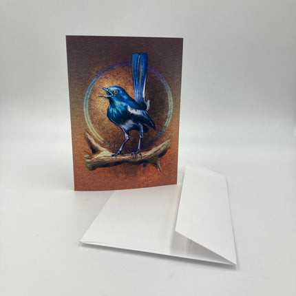 Greeting card with a blue bird illustration on a brown background, featuring a white envelope.