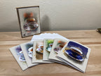 Set of greeting cards with coffee-themed designs on a wooden surface.