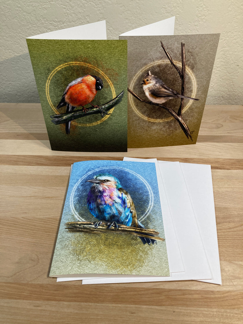 Three greeting cards with nature-themed designs on a wooden surface