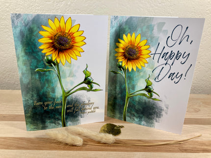 Two sunflower-themed greeting cards on a wooden surface with a blurred background.