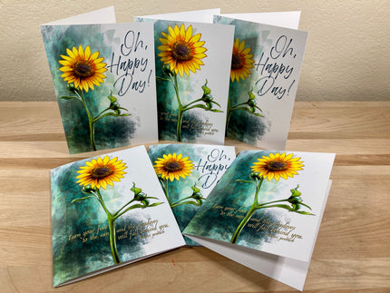 Set of sunflower-themed greeting cards on a wooden surface