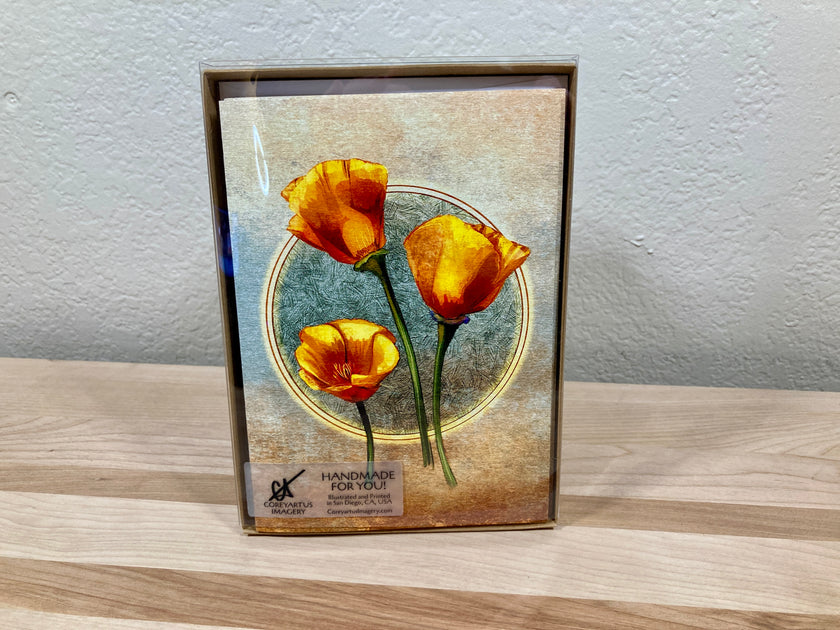 Greeting card pack in case, with orange flowers on a wooden surface