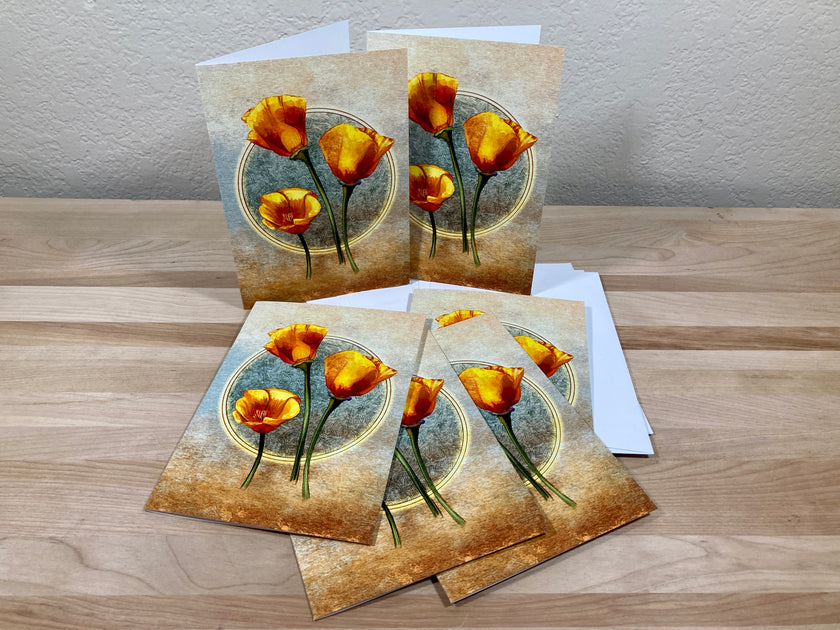 Set of greeting cards with floral design on a wooden surface