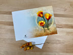 Greeting card with floral design on a wooden surface