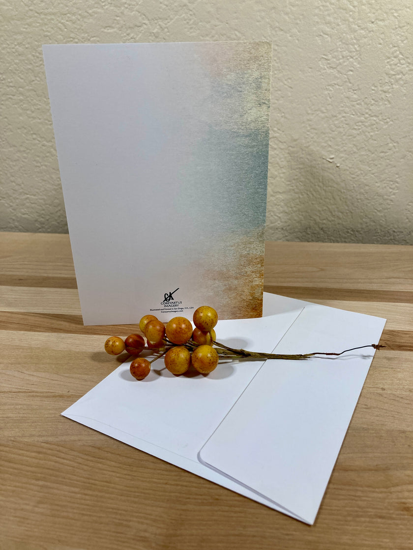 Greeting card with envelope and decorative branch on a wooden surface