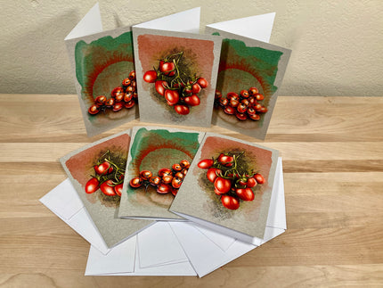 Set of greeting cards with red tomato illustrations on a wooden surface