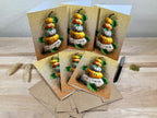 Set of Halloween-themed greeting cards with pumpkins and 'Happy Halloween' text on a wooden surface.