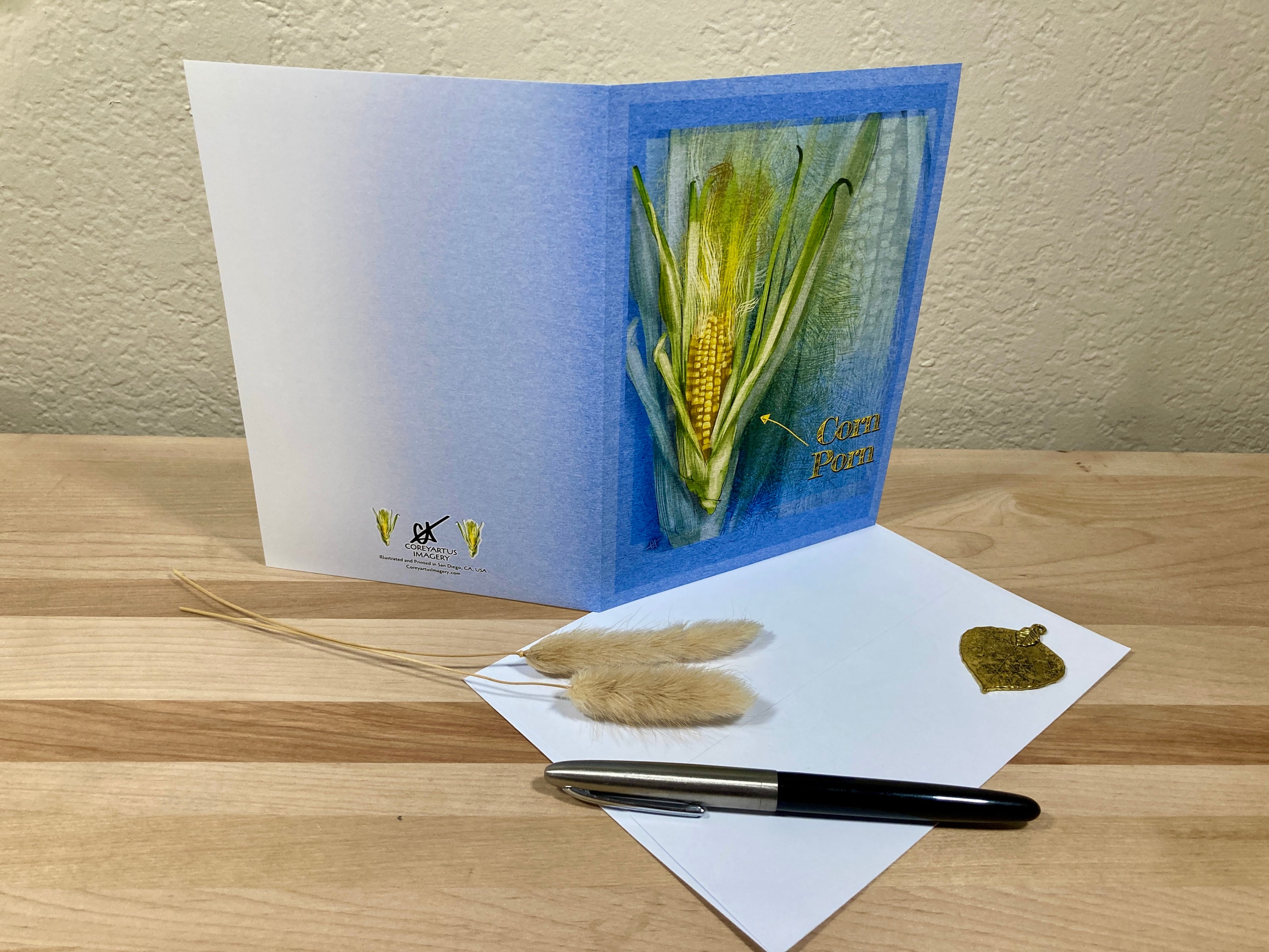Greeting card with corn design on a wooden surface