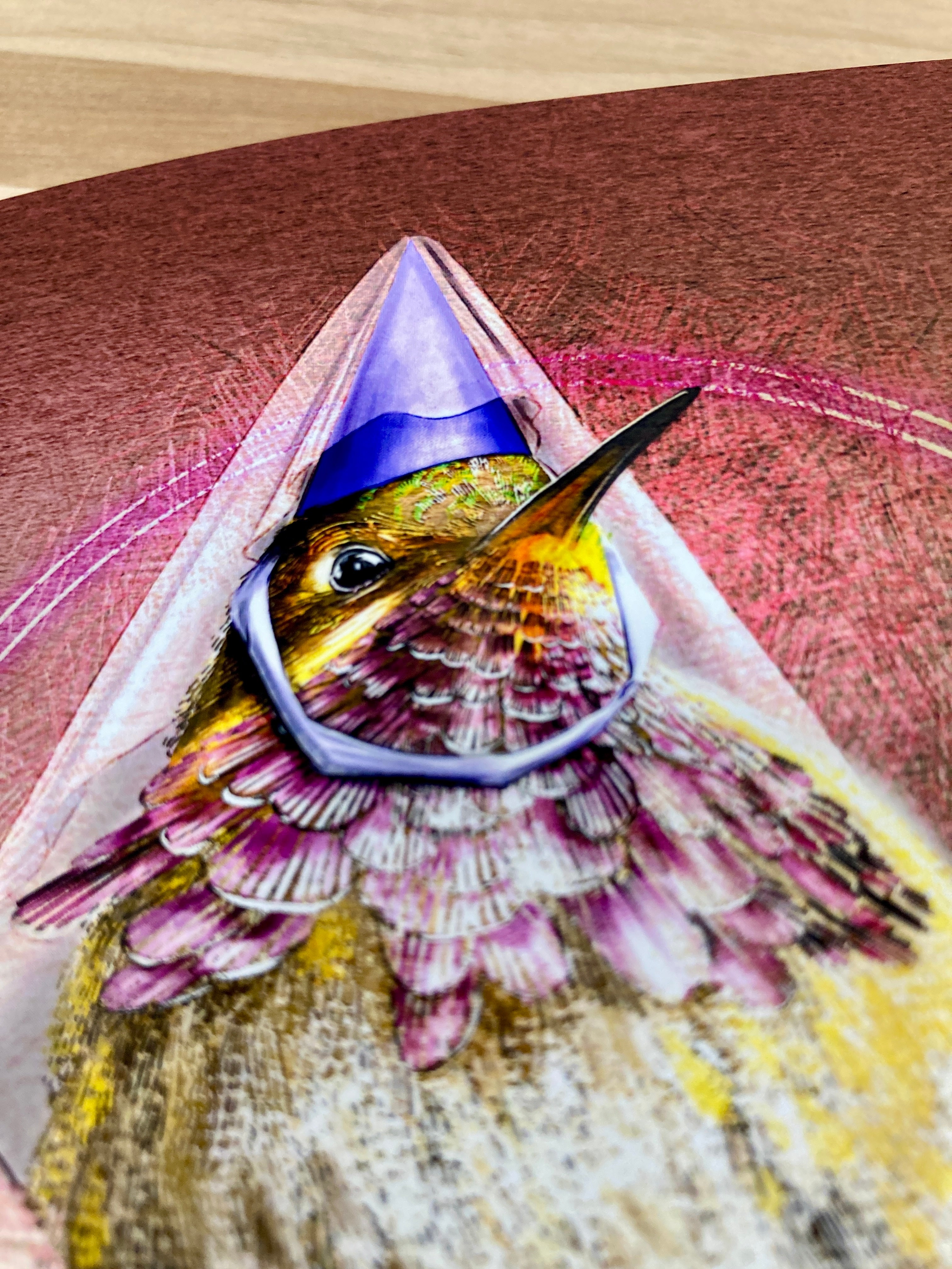 Hummingbird with a purple cone-shaped hat on a textured surface