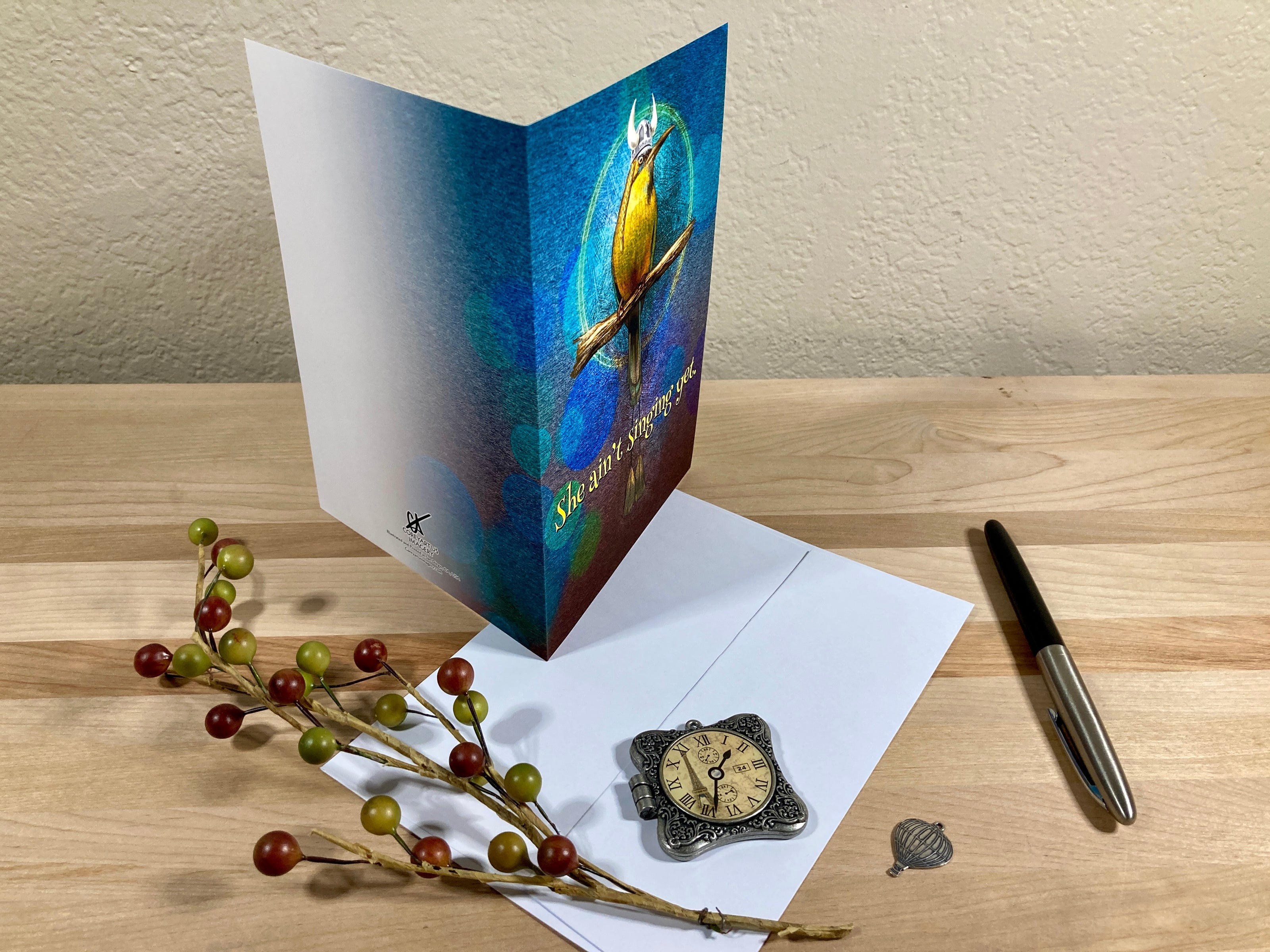 Greeting card with a turtle design on a wooden surface with decorative elements.
