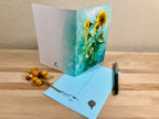Greeting card with sunflower design on a wooden surface