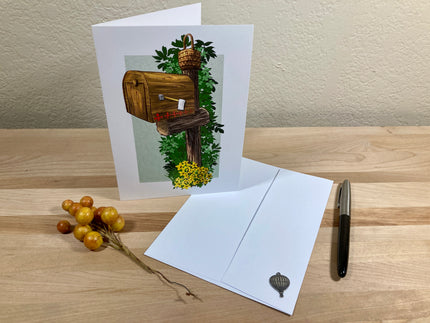 Greeting card with nature-themed illustration on a wooden surface