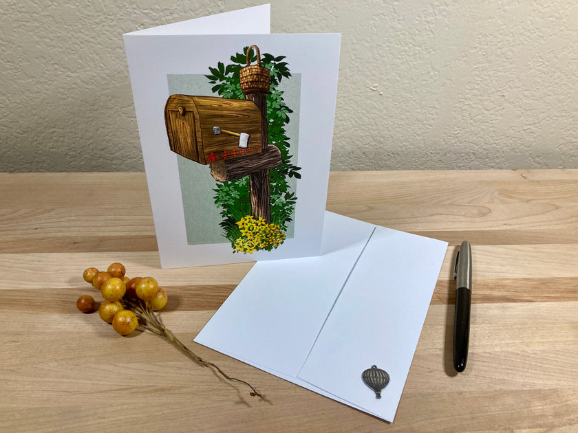Greeting card with nature-themed illustration on a wooden surface