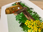 Greeting card featuring a wooden mailbox with leaves and flowers on a card