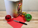 Greeting card with festive decorations on a wooden surface