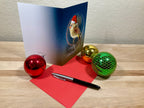 Christmas card with festive decorations on a wooden surface