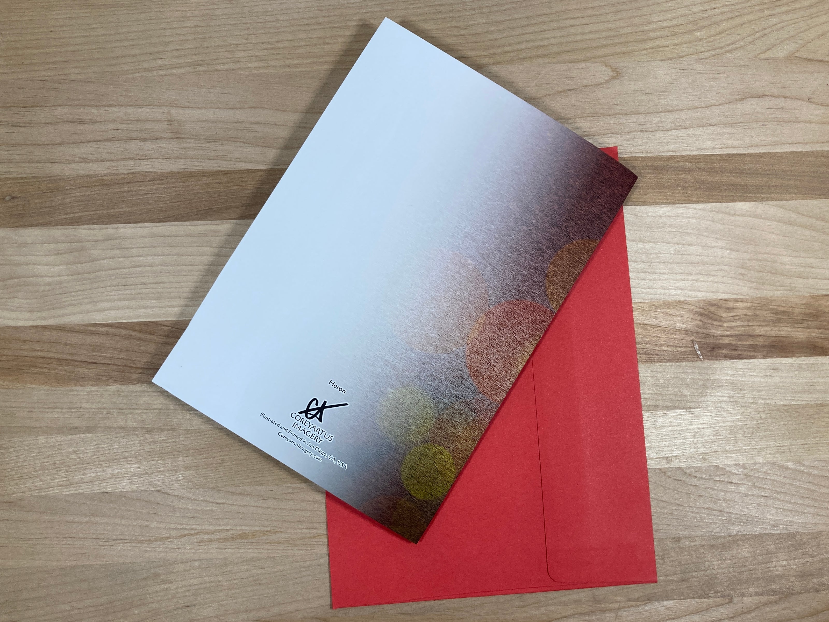Greeting card with red envelope on a wooden surface