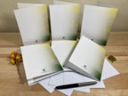 Set of greeting cards with envelopes on a wooden surface
