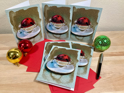 Set of greeting cards with Christmas-themed design on a wooden surface.