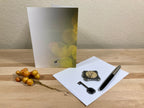 Greeting card with decorative items on a wooden surface