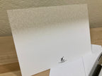 White paper with a logo on a wooden surface