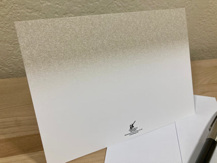 White paper with a logo on a wooden surface