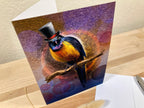 Greeting card with a colorful bird wearing a top hat on a wooden surface.