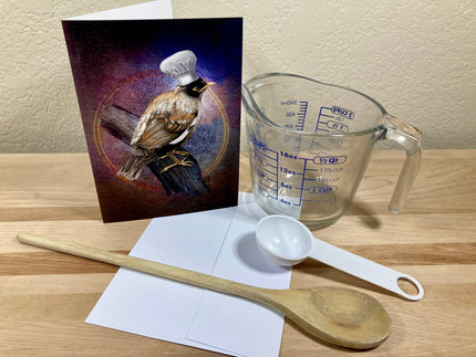 Measuring cup, wooden spoon, and card on a wooden surface