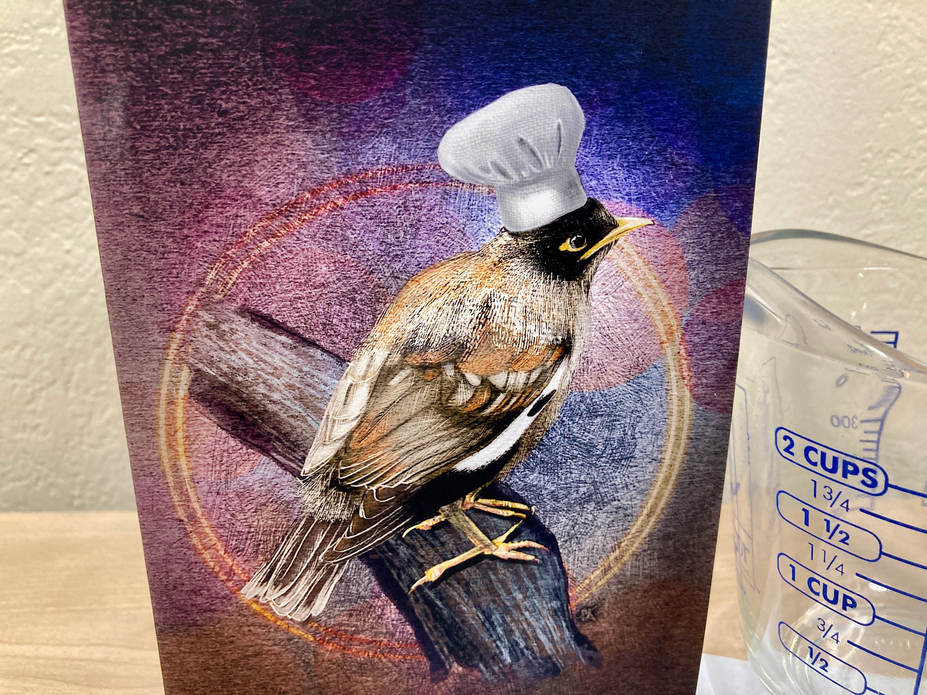Bird illustration on a card with a measuring cup in the background