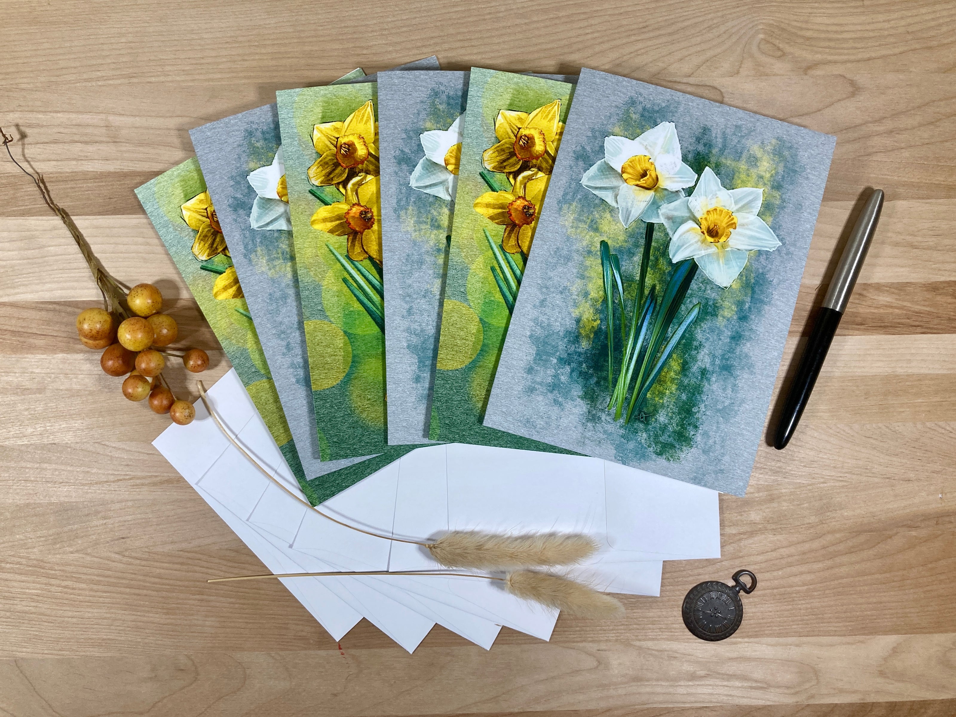 Set of greeting cards with floral designs on a wooden surface
