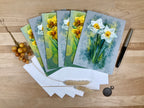 Set of greeting cards with floral designs on a wooden surface