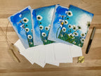 Set of floral greeting cards with envelopes on a wooden surface