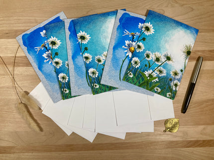 Set of floral greeting cards with envelopes on a wooden surface