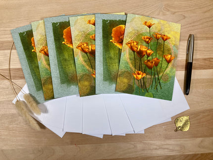 Set of greeting cards with floral design on a wooden surface