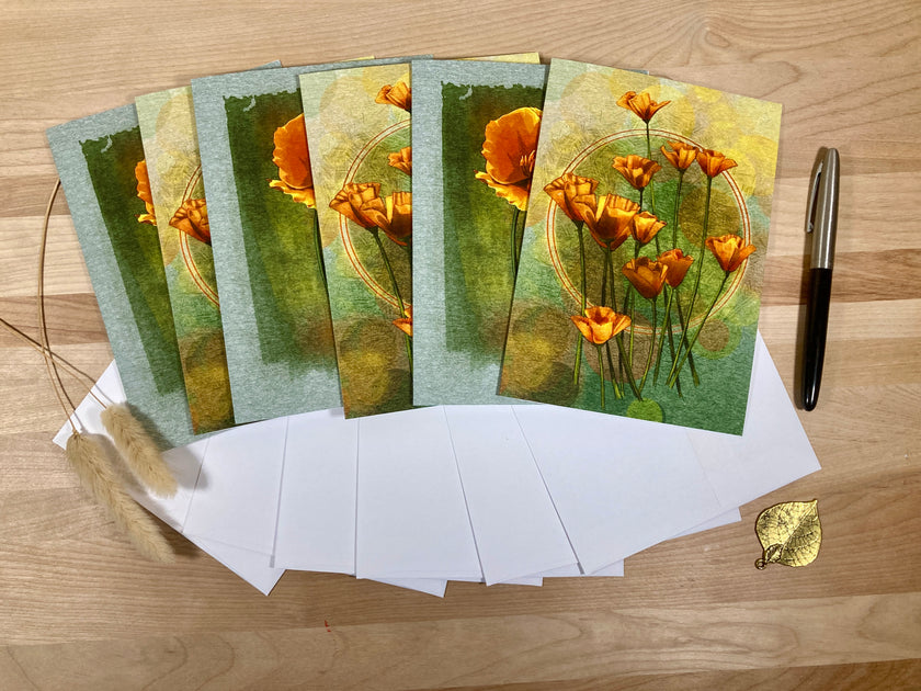 Set of greeting cards with floral design on a wooden surface