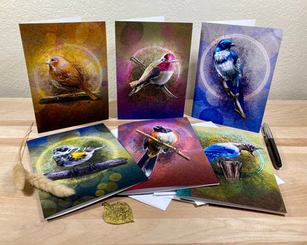 Set of six greeting cards with bird illustrations on a wooden surface.
