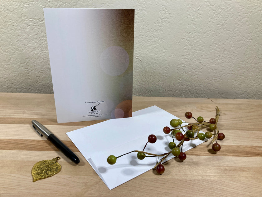 White card with a pen and decorative branch on a wooden surface