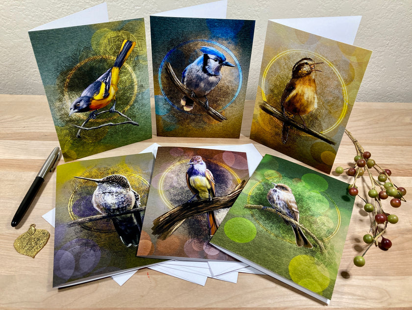 Set of six greeting cards with bird illustrations on a wooden surface.