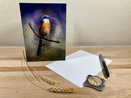 Greeting card with a bird design on a wooden surface with paper and pen.