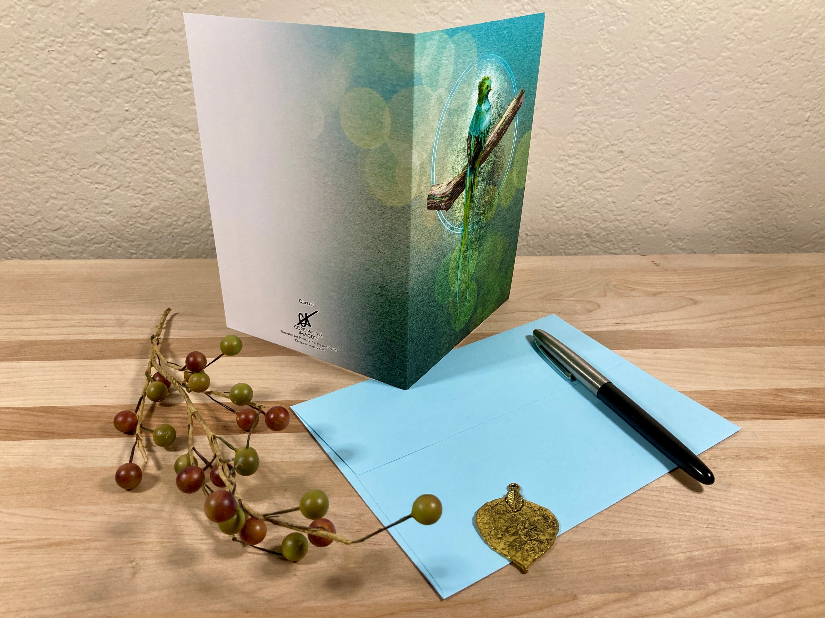 Greeting card with envelope and pen on a wooden surface